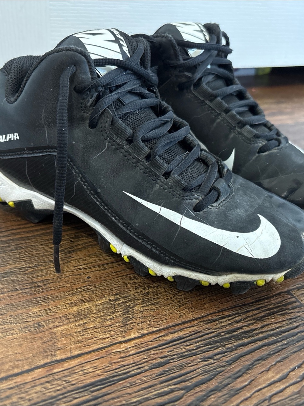 Nike Black Cleats with White Swoosh and Yellow Studs